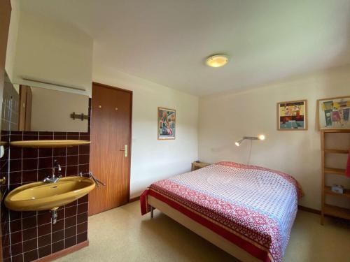 a bedroom with a bed and a sink at Appartement Le Grand-Bornand, 2 pièces, 5 personnes - FR-1-241-142 in Le Grand-Bornand
