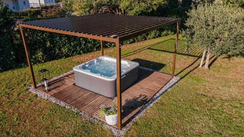 a hot tub in a gazebo in a yard at Residence Il Melograno in Manerba del Garda