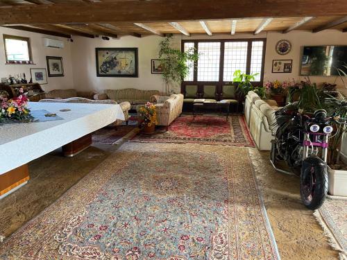 a living room with couches and a large rug at Fattoria Raffaelli in Colle Farnese