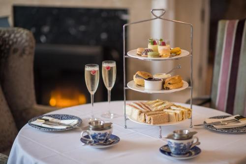 a table with a plate of food and two glasses of champagne at The Imperial Hotel in Barnstaple