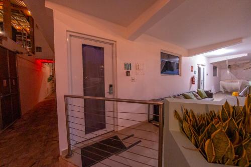 a room with a balcony with a view of a living room at Casa Verde Hotel - Steps to the Beach, Pool, Restaurant & Bar in Rincon