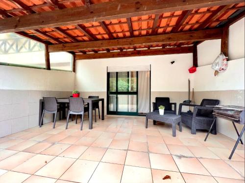 a living room with a table and chairs at Studio Gerês in Geres