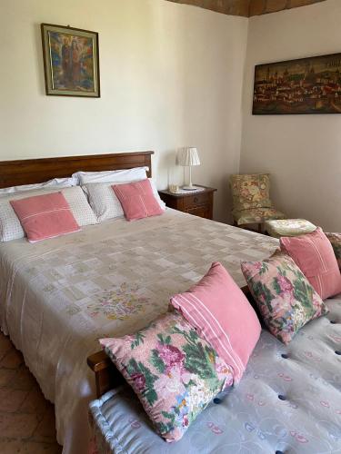 a bedroom with a large bed with pink pillows at Torre Colombaia in Salsomaggiore Terme