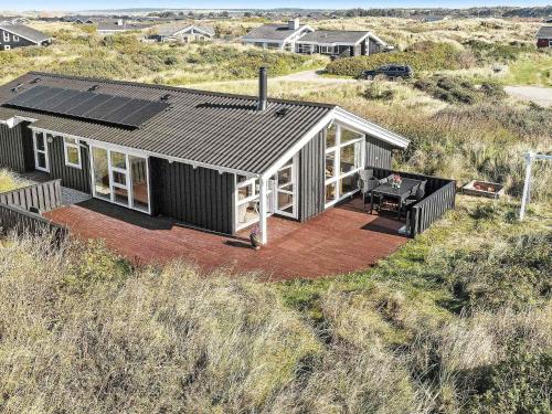 an overhead view of a house with solar panels on it at 8 person holiday home in Hj rring in Kærsgård Strand