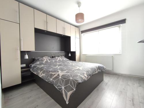 a bedroom with a bed and a large window at CASA VICTORIA in Victoria