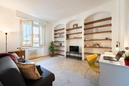 a living room with a couch and a desk at Beccaria - Flo Apartments in Florence
