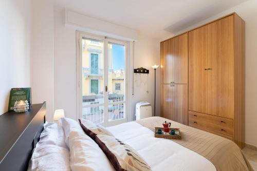 a bedroom with a large bed and a window at Beccaria - Flo Apartments in Florence