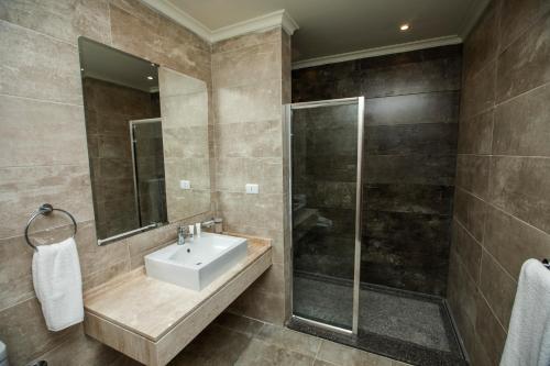 a bathroom with a sink and a shower at AIFU Hotel El Montazah Alexandria in Alexandria