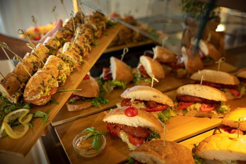 a buffet of sandwiches and other food on a table at Sunny Dubrovnik by Valamar in Dubrovnik