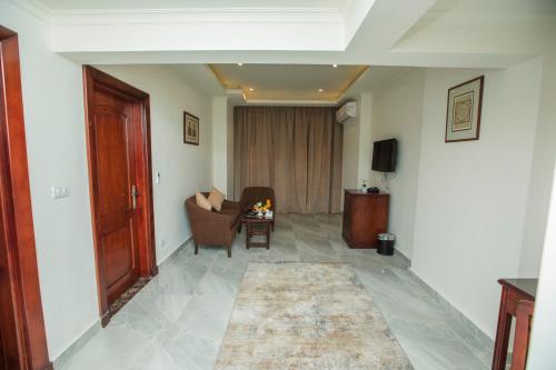 a living room with a couch and a chair at AIFU Hotel El Montazah Alexandria in Alexandria