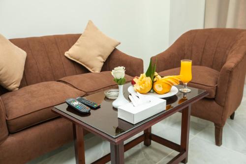 a living room with a couch and a coffee table at AIFU Hotel El Montazah Alexandria in Alexandria