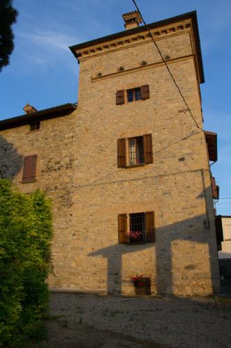 a tall brick building with windows on the side of it at Torre Colombaia in Salsomaggiore Terme