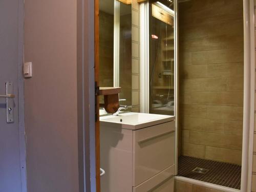 W łazience znajduje się biała umywalka i lustro. w obiekcie Appartement Méribel, 1 pièce, 5 personnes - FR-1-180-304 w Méribel