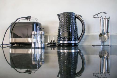 a blender sitting on top of a glass table at Shany’s Villa 3bdrm with private swimming pool in Mombasa