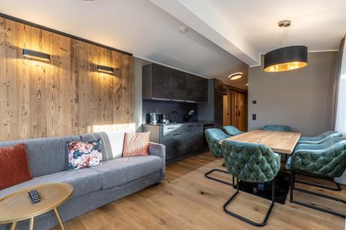 a living room with a couch and a table at Zugspitz Residence Ehrwald in Ehrwald