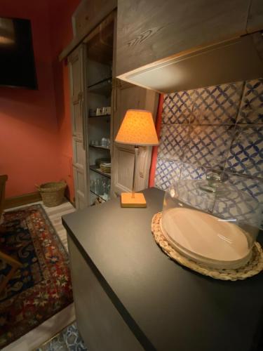 a table with a lamp on top of a counter at B & B Beata Colomba in Rieti