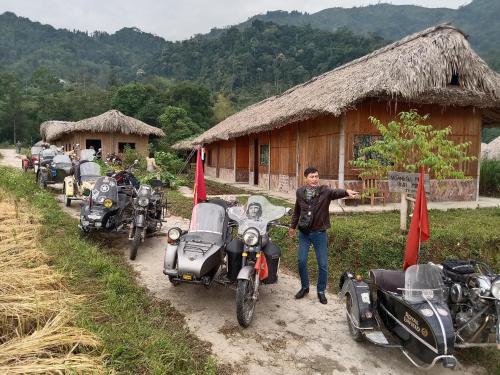 a man standing in front of a row of motorcycles at Bình Minh Homestay in Nam Giang