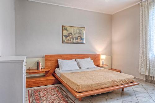 1 dormitorio con 1 cama con cabecero de madera en Villa Egola, en San Miniato