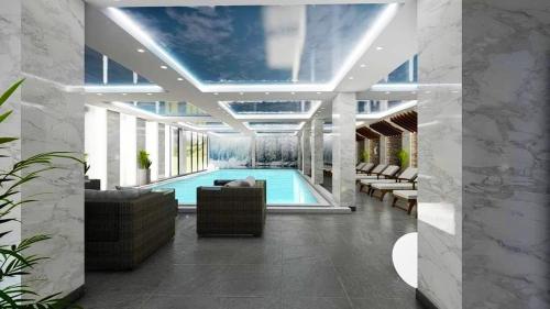 a swimming pool with a couch and chairs in a building at President KOP A515 in Kopaonik