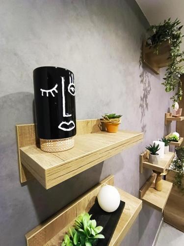 a black and white towel on a shelf with plants at President KOP A515 in Kopaonik