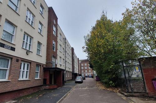 a street with buildings and a car parked on the road at Charming flat near Shoreditch in London