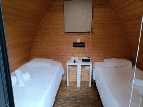 a room with two beds and a table in it at Solmeco Park in Aldeia do Meco