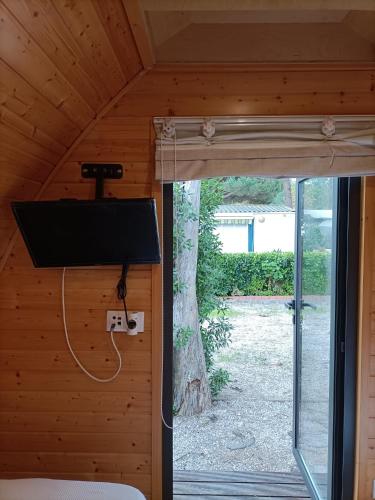 a view of a room with a tv and a window at Solmeco Park in Aldeia do Meco