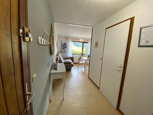 a hallway with a living room with a couch and a table at Studio Le Grand-Bornand, 1 pièce, 4 personnes - FR-1-241-19 in Le Grand-Bornand