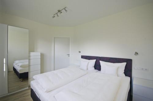 Katil atau katil-katil dalam bilik di Appartements Am Kurpark