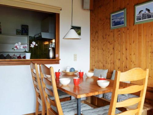 a wooden dining room table with chairs and a kitchen at Appartement Le Grand-Bornand, 2 pièces, 5 personnes - FR-1-241-101 in Le Grand-Bornand