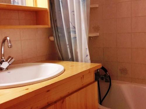 a bathroom with a sink and a shower and a tub at Appartement Le Grand-Bornand, 2 pièces, 6 personnes - FR-1-241-21 in Le Grand-Bornand