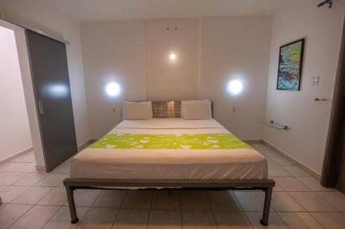 a bedroom with a large bed in a room at Casa Verde Hotel - Steps to the Beach, Pool, Restaurant & Bar in Rincon