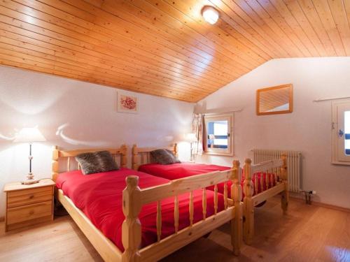 a bedroom with two beds and a wooden ceiling at Appartement Le Grand-Bornand, 3 pièces, 6 personnes - FR-1-241-117 in Le Grand-Bornand