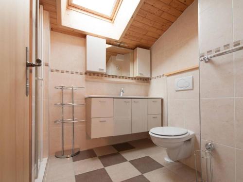 a bathroom with a toilet and a sink and a skylight at Appartement Le Grand-Bornand, 3 pièces, 6 personnes - FR-1-241-117 in Le Grand-Bornand