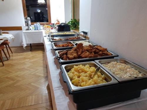 a buffet line with many different types of food at Kurhotel Renona Rehabilitation in Semmering