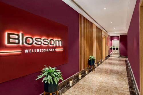 a hallway of a hotel with a sign on the wall at Wyndham Doha West Bay in Doha