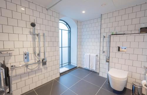 a bathroom with a shower and a toilet at The Wesley Camden Town in London