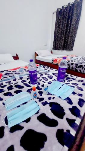 two bottles of water sitting on top of a bed at Nilam Guest House in Bodh Gaya