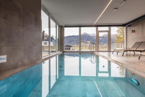 a swimming pool with a view of the mountains at Zugspitz Residence Ehrwald in Ehrwald