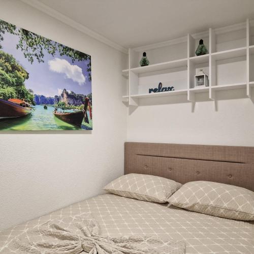 a bedroom with a bed with a picture on the wall at Villa Bali - Aladinici in Stolac