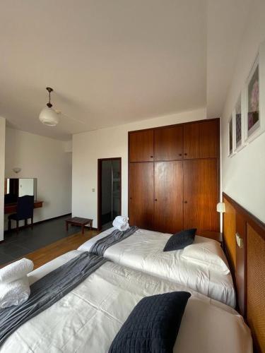 a bedroom with a large bed with a wooden headboard at Valhalla Panorama in Funchal