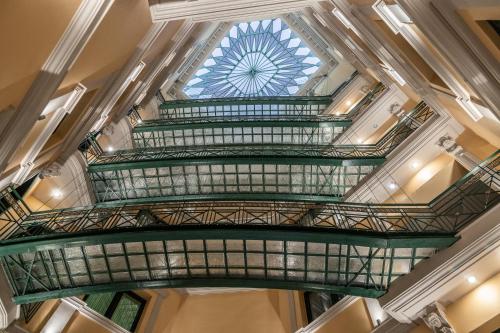 a spiral staircase in a building with a glass ceiling at ExAnimo Luxury Apartments in Zakynthos Town