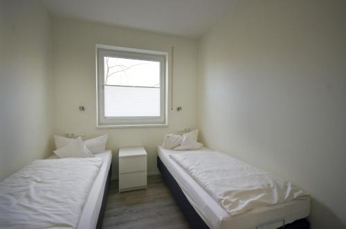 Katil atau katil-katil dalam bilik di Appartements Am Kurpark