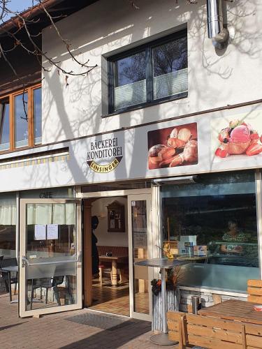 a bakery building with a sign on the front of it at Landhaus Ammer in Oberndorf in Tirol