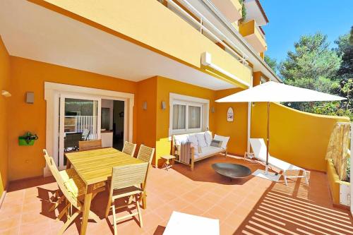 a patio with a table and chairs and an umbrella at Tropical Pool View Cascais - Checkinhome in Cascais