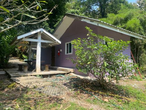 a small purple house with a white cross on it at ทับศิลารีสอร์ท Tubsila Resort in Chongsadao