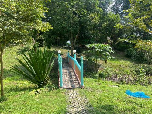 a fence in the middle of a garden at ทับศิลารีสอร์ท Tubsila Resort in Chongsadao