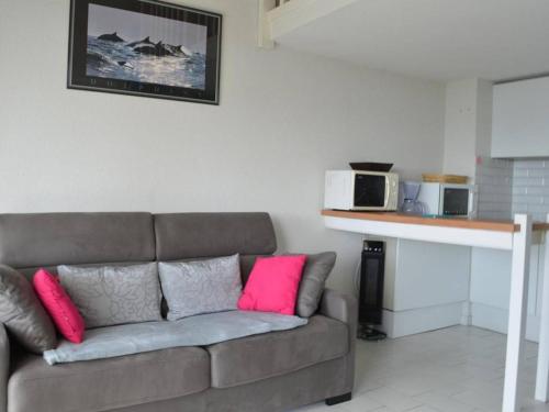 - un salon avec un canapé et 2 oreillers roses dans l'établissement Location Appart 2 pièces au port d'Argelès-sur-Mer - FR-1-225-56, à Argelès-sur-Mer