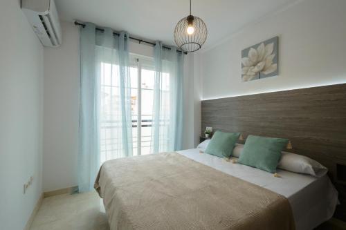 um quarto com uma cama grande e uma janela grande em DUPLEX VISTANEVADA MARACENA em Maracena