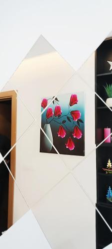 a painting of red flowers on a wall at President KOP A515 in Kopaonik